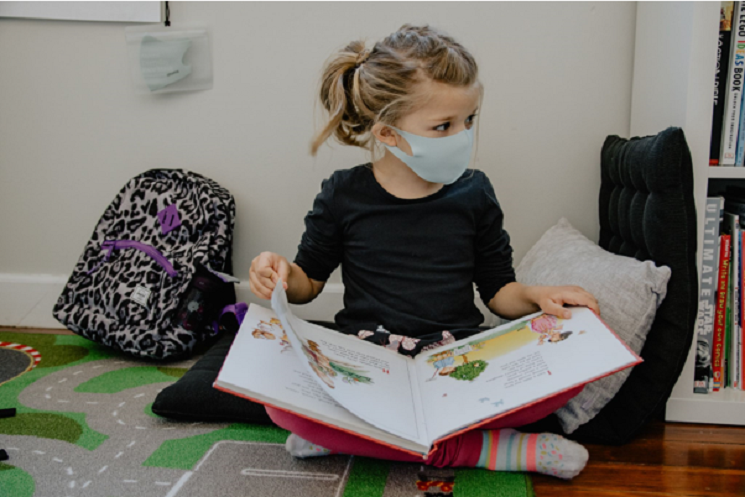 une petite fille lit un livre